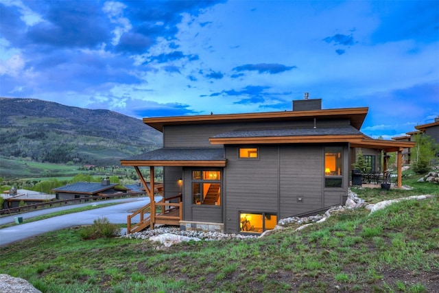 53 Hargrove Way, Silverthorne, CO 80498 - back of property with a chimney, a mountain view, and a shingled roof
