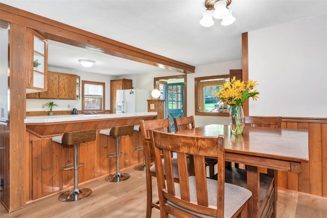 211 W Oak St, Oak Creek, CO 80467 - dining space featuring light wood-style flooring, plenty of natural light, and beamed ceiling