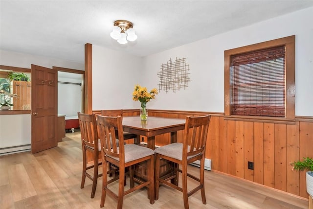211 W Oak St, Oak Creek, CO 80467 - dining space with light wood-style floors, wainscoting, a chandelier, baseboard heating, and a baseboard heating unit