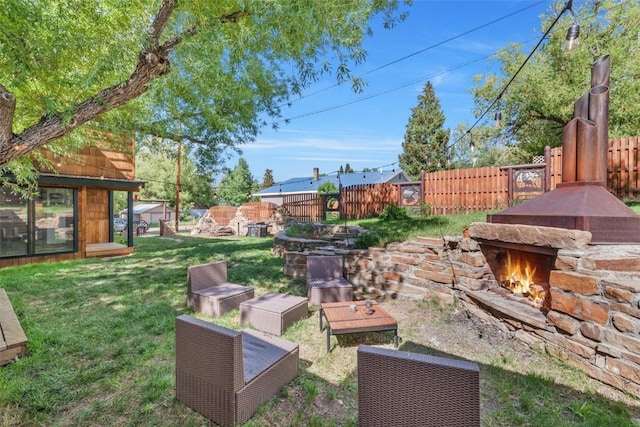 211 W Oak St, Oak Creek, CO 80467 - fenced backyard featuring an outdoor stone fireplace