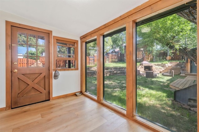 211 W Oak St, Oak Creek, CO 80467 - doorway to outside featuring wood finished floors and vaulted ceiling