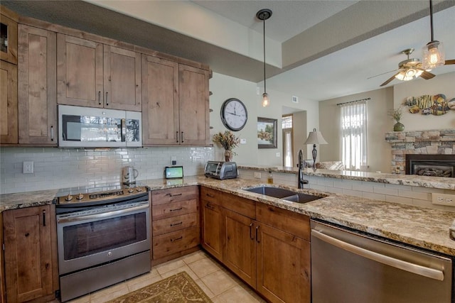 131 Allegra Ln Unit 131, Silverthorne, CO 80498 - kitchen featuring appliances with stainless steel finishes, a sink, backsplash, light tile patterned flooring, and ceiling fan