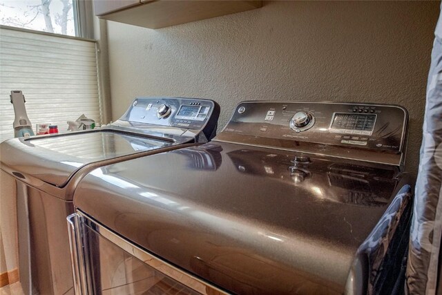 131 Allegra Ln Unit 131, Silverthorne, CO 80498 - clothes washing area with washing machine and dryer and a textured wall