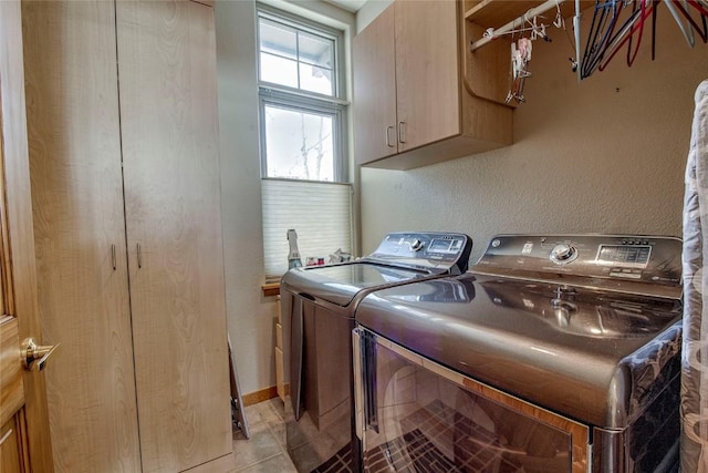 131 Allegra Ln Unit 131, Silverthorne, CO 80498 - clothes washing area featuring washer and clothes dryer, cabinet space, and light tile patterned flooring