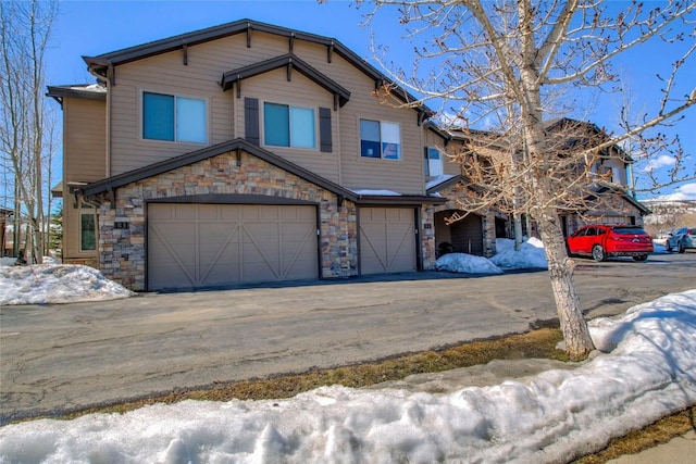 131 Allegra Ln Unit 131, Silverthorne, CO 80498 - craftsman house featuring a garage, stone siding, and asphalt driveway