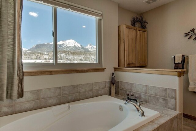 131 Allegra Ln Unit 131, Silverthorne, CO 80498 - full bath with healthy amount of natural light, a garden tub, and a mountain view