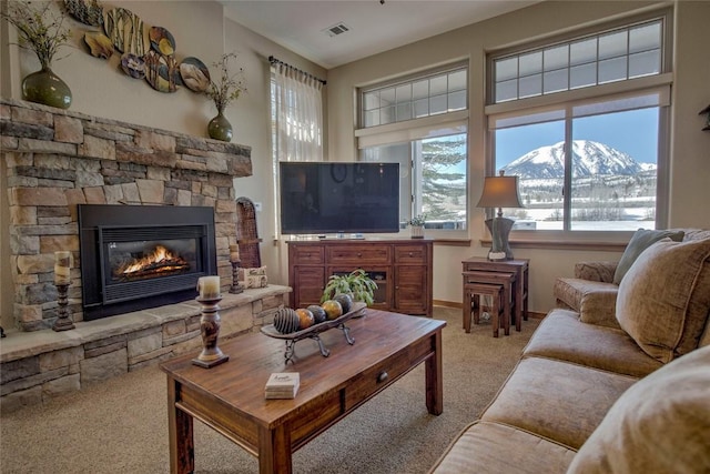 131 Allegra Ln Unit 131, Silverthorne, CO 80498 - carpeted living area with healthy amount of natural light, a fireplace, and baseboards