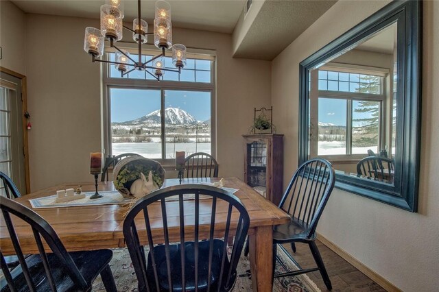 131 Allegra Ln Unit 131, Silverthorne, CO 80498 - dining space with a mountain view, plenty of natural light, a chandelier, and baseboards