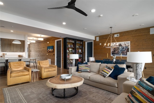 1460 Bangtail Way Unit 1B, Steamboat Springs, CO 80487 - living area featuring wooden walls, a chandelier, ceiling fan, wood finished floors, and recessed lighting