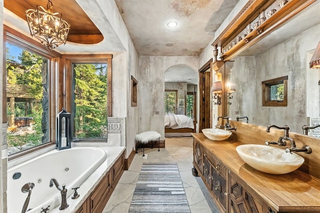165 River Park Dr, Breckenridge, CO 80424 - ensuite bathroom featuring plenty of natural light, double vanity, a whirlpool tub, and a chandelier