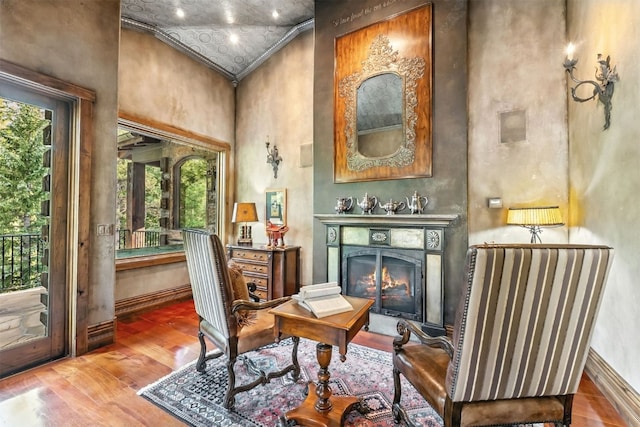 165 River Park Dr, Breckenridge, CO 80424 - sitting room featuring a lit fireplace, a high ceiling, wood finished floors, and ornamental molding