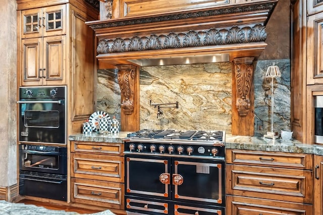 165 River Park Dr, Breckenridge, CO 80424 - kitchen with gas range, a warming drawer, stone counters, and brown cabinetry