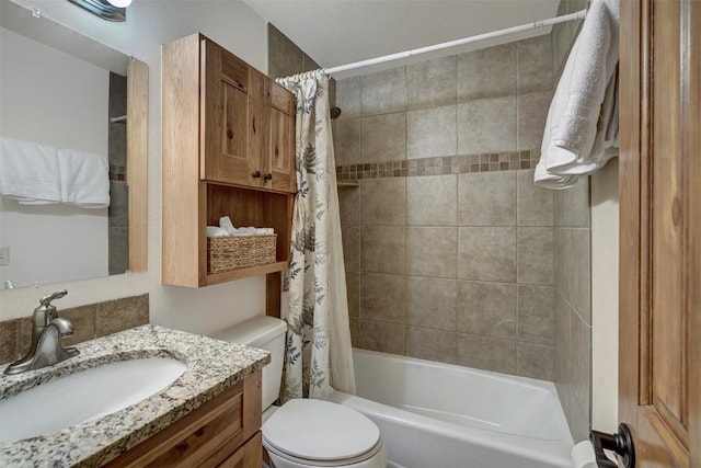 bathroom featuring shower / tub combo, toilet, and vanity