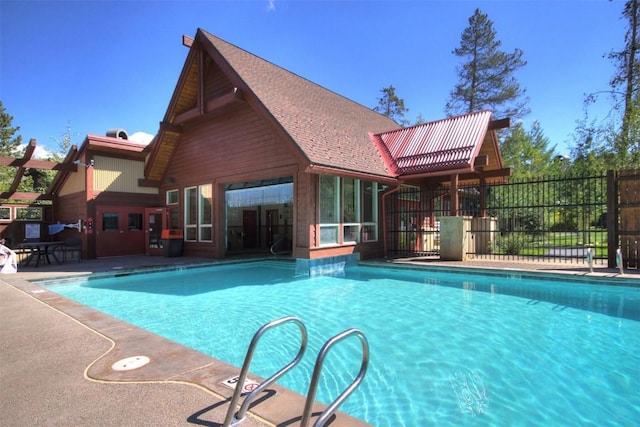 view of swimming pool featuring fence, a patio, and a fenced in pool