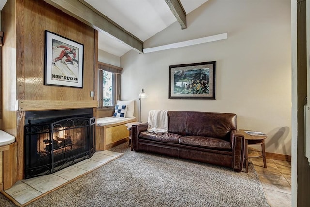 interior space featuring lofted ceiling with beams, baseboards, and a lit fireplace