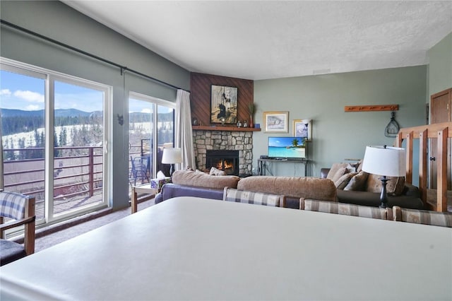 living room with carpet flooring, a fireplace, and a mountain view