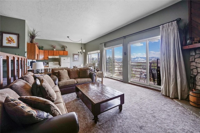 carpeted living area with a chandelier, a textured ceiling, and plenty of natural light