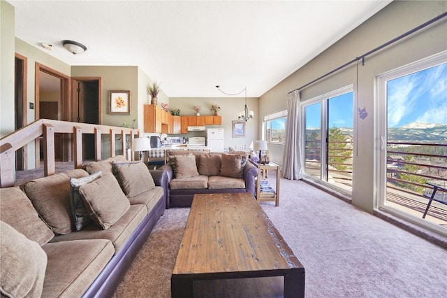 living area featuring a chandelier and light colored carpet