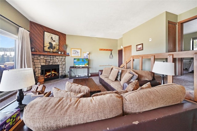 living area featuring a healthy amount of sunlight, carpet flooring, and a fireplace