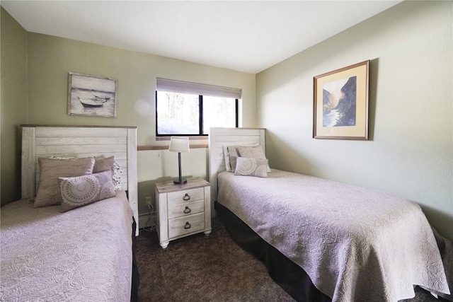 bedroom featuring dark carpet