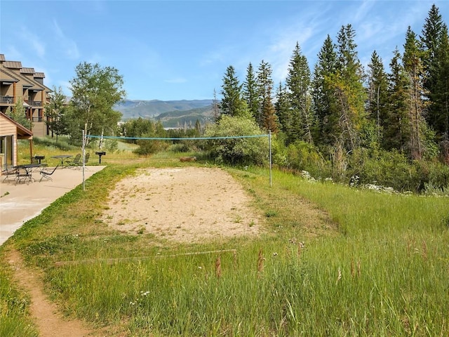 view of community with volleyball court and a mountain view