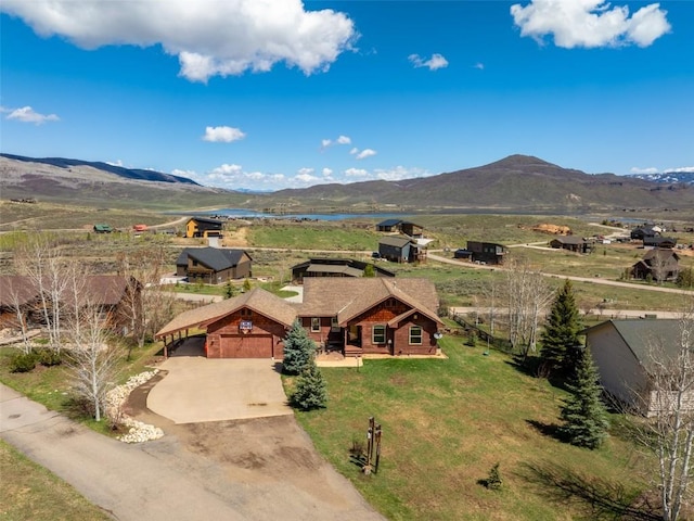 birds eye view of property featuring a water and mountain view