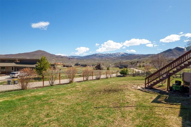 30225 Coyote Run Ct, Oak Creek, CO 80467 - view of yard with fence, a mountain view, and stairs