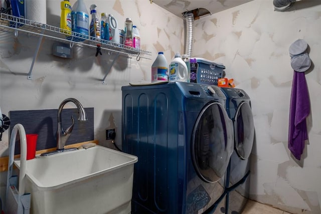 washroom featuring laundry area, a sink, and washing machine and dryer