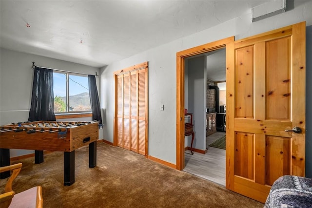 game room with baseboards and carpet