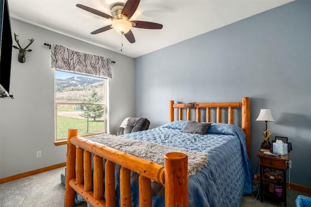 bedroom with carpet flooring, a ceiling fan, and baseboards