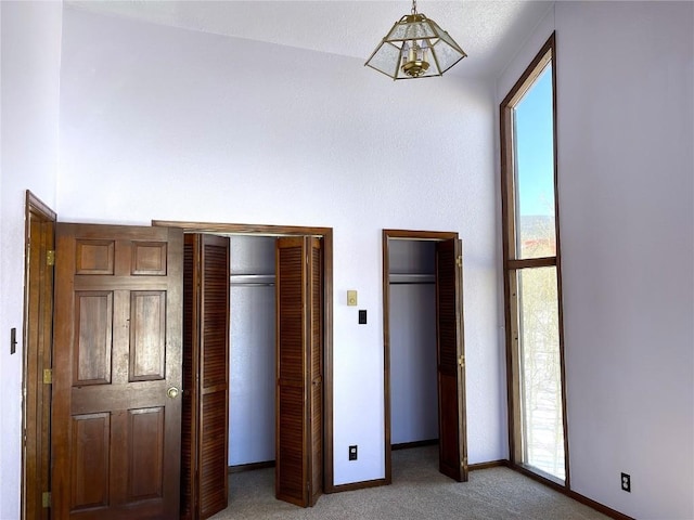 2584 High Creek Rd, Fairplay, CO 80440 - unfurnished bedroom featuring light colored carpet, baseboards, and multiple windows