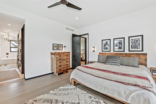 582 Laurel St, Steamboat Springs, CO 80487 - bedroom featuring wood finished floors, connected bathroom, recessed lighting, a chandelier, and ceiling fan