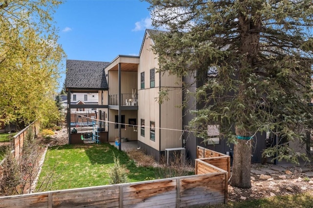582 Laurel St, Steamboat Springs, CO 80487 - rear view of property featuring a balcony, roof with shingles, and cooling unit