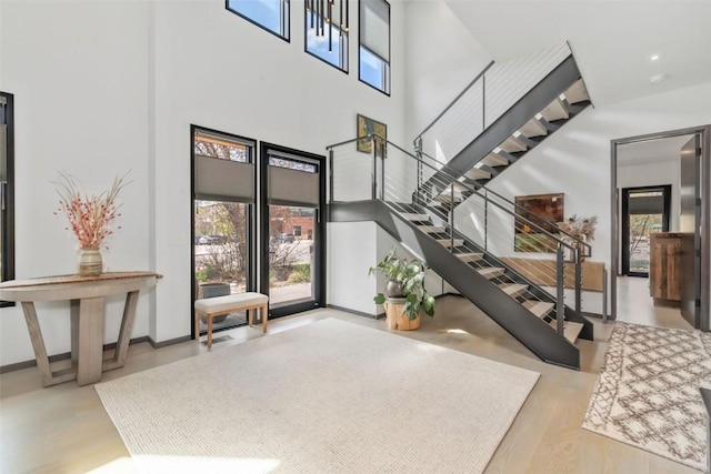 582 Laurel St, Steamboat Springs, CO 80487 - foyer entrance featuring a high ceiling, healthy amount of natural light, stairs, and wood finished floors
