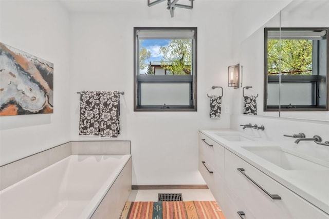 582 Laurel St, Steamboat Springs, CO 80487 - full bathroom featuring a bath, double vanity, and baseboards