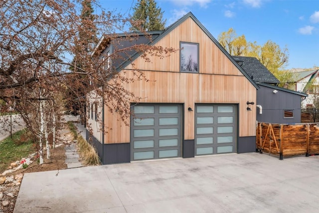 582 Laurel St, Steamboat Springs, CO 80487 - garage with concrete driveway and fence