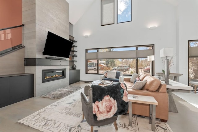 582 Laurel St, Steamboat Springs, CO 80487 - living area featuring a towering ceiling, a fireplace, and healthy amount of natural light