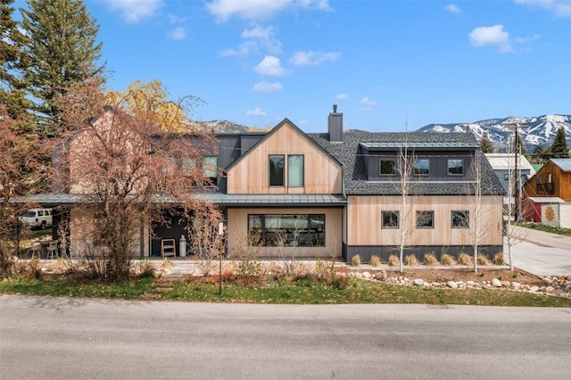 582 Laurel St, Steamboat Springs, CO 80487 - view of front of house with a chimney, a standing seam roof, and metal roof
