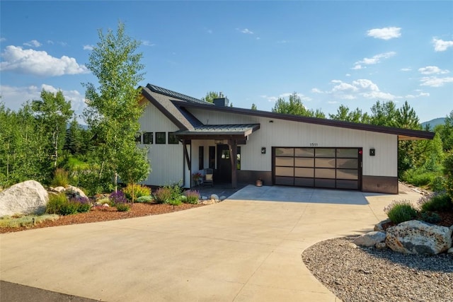 1511 Harwig Cir, Steamboat Springs, CO 80487 - view of front facade featuring an attached garage, driveway, and roof mounted solar panels