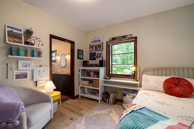 1511 Harwig Cir, Steamboat Springs, CO 80487 - bedroom with connected bathroom and wood finished floors