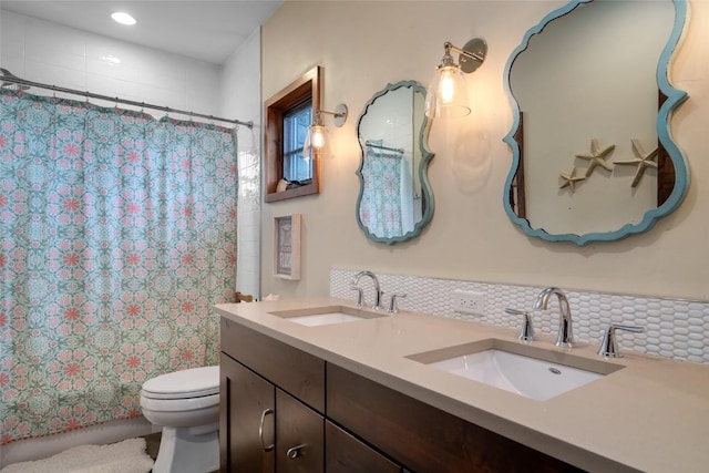 1511 Harwig Cir, Steamboat Springs, CO 80487 - full bathroom featuring double vanity, toilet, a sink, and tasteful backsplash