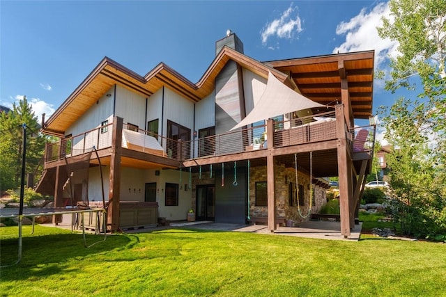 1511 Harwig Cir, Steamboat Springs, CO 80487 - rear view of property with a wooden deck, a patio, a chimney, and a yard