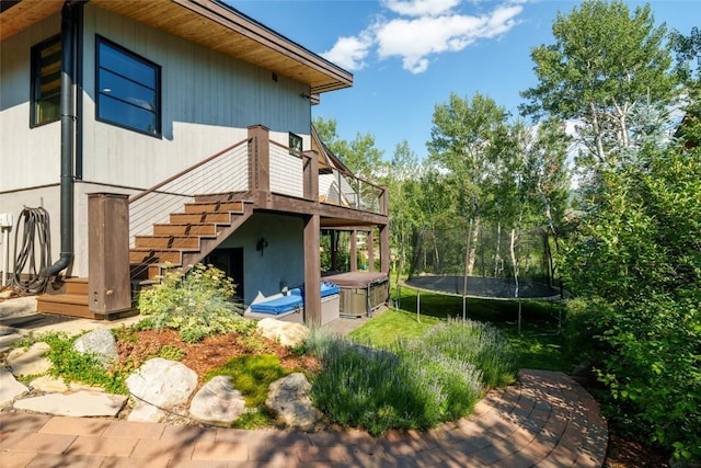 1511 Harwig Cir, Steamboat Springs, CO 80487 - exterior space featuring a deck, stairs, a trampoline, and a jacuzzi