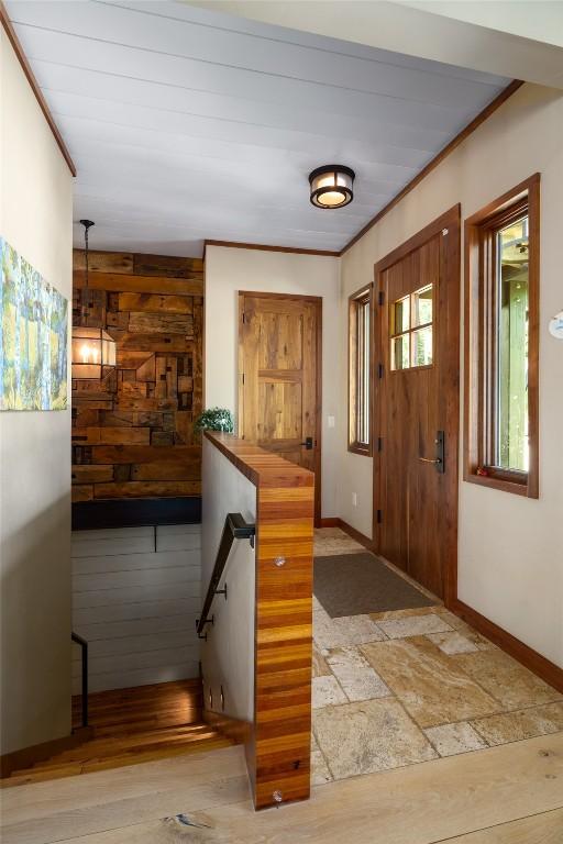 1511 Harwig Cir, Steamboat Springs, CO 80487 - foyer entrance with baseboards, ornamental molding, and wood walls