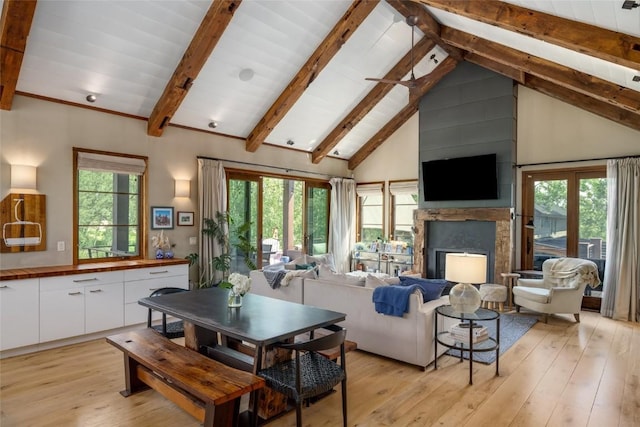 1511 Harwig Cir, Steamboat Springs, CO 80487 - living area featuring a high end fireplace, light wood-style flooring, high vaulted ceiling, and beamed ceiling
