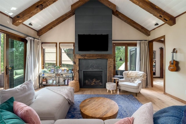 1511 Harwig Cir, Steamboat Springs, CO 80487 - living room featuring a healthy amount of sunlight, a high end fireplace, beam ceiling, and wood finished floors