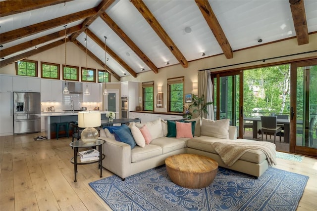1511 Harwig Cir, Steamboat Springs, CO 80487 - living room featuring light wood-type flooring, beam ceiling, a healthy amount of sunlight, and high vaulted ceiling
