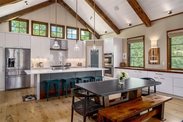 1511 Harwig Cir, Steamboat Springs, CO 80487 - dining space with beamed ceiling, high vaulted ceiling, and light wood-style flooring