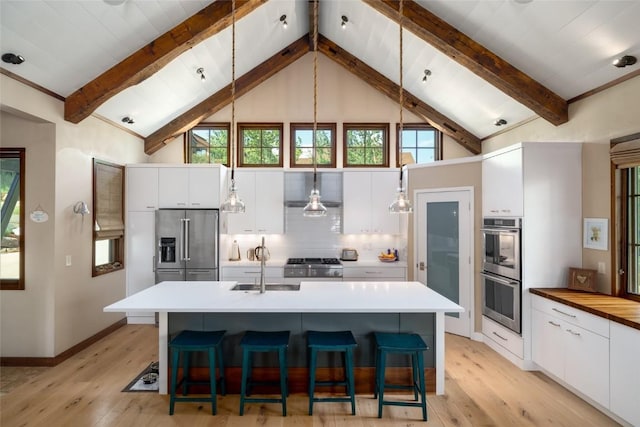 1511 Harwig Cir, Steamboat Springs, CO 80487 - kitchen featuring a sink, light wood finished floors, appliances with stainless steel finishes, and white cabinets