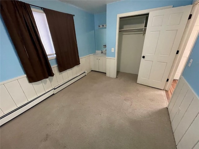 810 Broad St, Steamboat Springs, CO 80487 - unfurnished bedroom featuring a baseboard radiator, a closet, light colored carpet, and a sink